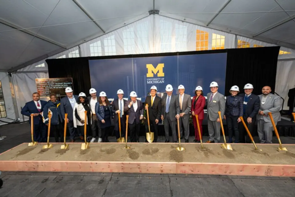 U-M and Detroit leaders pose with hard hats and shovels to commemorate the UMCI groundbreaking