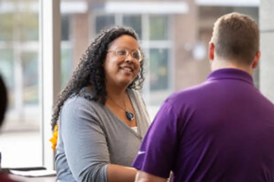 Lauren Atkins Budde speaking with another attendee